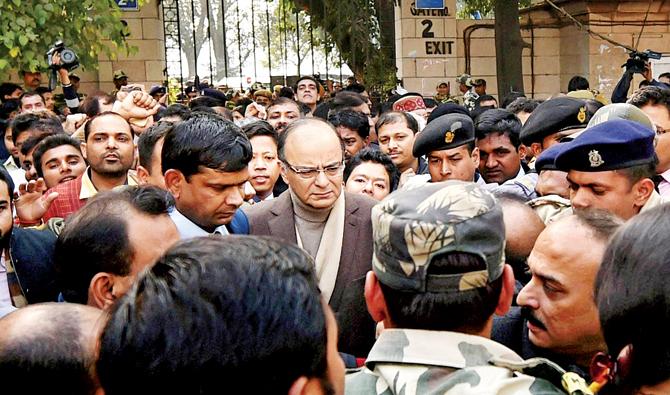 Finance Minister Arun Jaitley surrounded by security and party workers as he arrives at Patiala House Courts yesterday. pic/PTI 
