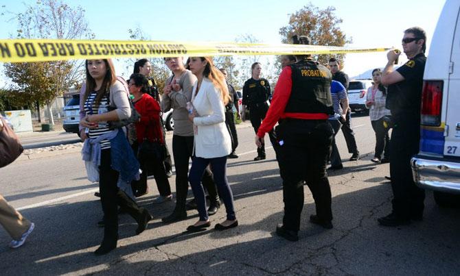 Survivors are evacuated from the scene of the shooting under police and sheriff