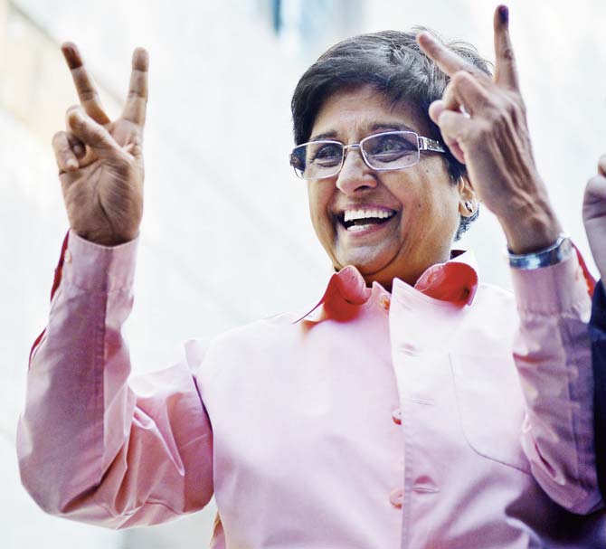 BJP’s candidate for Delhi CM, Kiran Bedi greets supporters after casting her vote at a polling station in New Delhi. Exit polls show that the ‘master-stroke’ of pulling in Bedi into the party a day before projecting her as Chief Ministerial candidate was a horrendous miscalculation. Pic/AFP