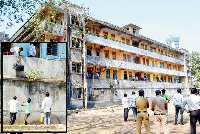 The BMC began demolition of the hostel, built in 1964, yesterday. (Left) A student who had somehow managed to stay inside when the others were asked to get out, tried to save their belongings by passing them down from the balcony.  Pics/Datta Kumbhar 