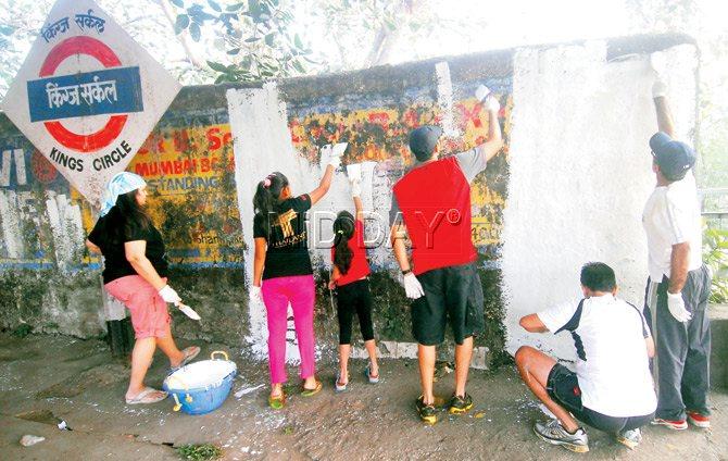 PAINTING PROWESS: Volunteers whitewash the walls on Platform 2 