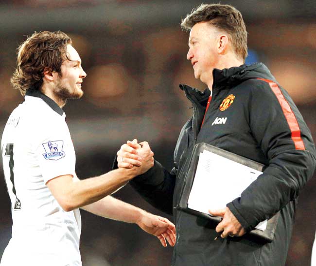 United boss Louis van Gaal (right) shakes hands with Daley Blind after the latter scored against West Ham. Pic/AFP