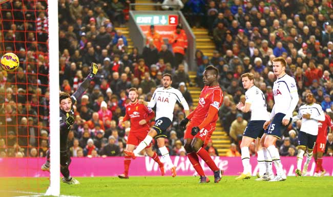 Liverpool striker Mario Balotelli (right) scores against Tottenham Hotspur at Anfield on Tuesday. Pic/Getty Images 