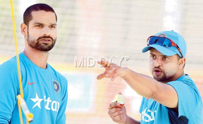 Suresh Raina (with apple in hand) and Shikhar Dhawan at St Peter’s College Oval nets at Adelaide yesterday PIC/Suman Chattopadhyay 