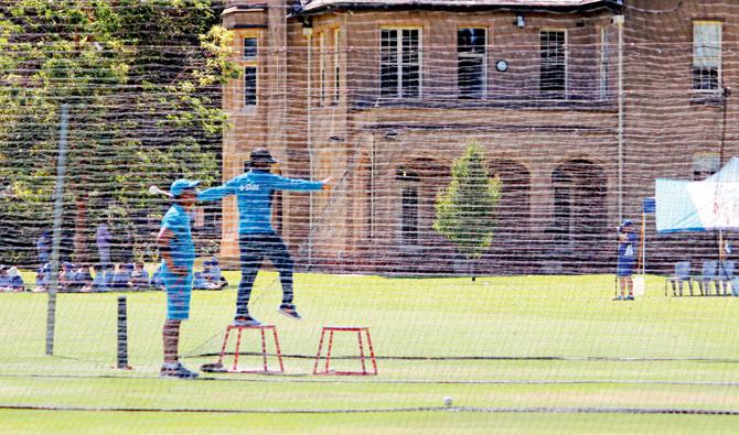 A member of Team India’s support staff uses a stool to execute throw downs during a training session in order to tackle bowler Mohammad Irfan
