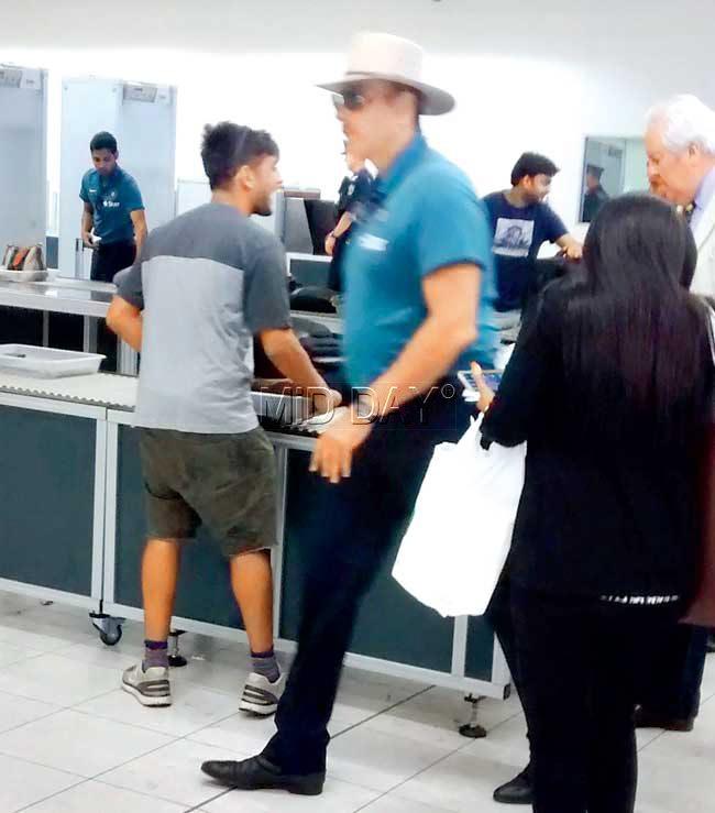 India Team Director Ravi Shastri, wearing a hat and sunglasses, heads for the security check. Moments later, he had to remove his hat and take off his metal-framed sunglasses and walk through again