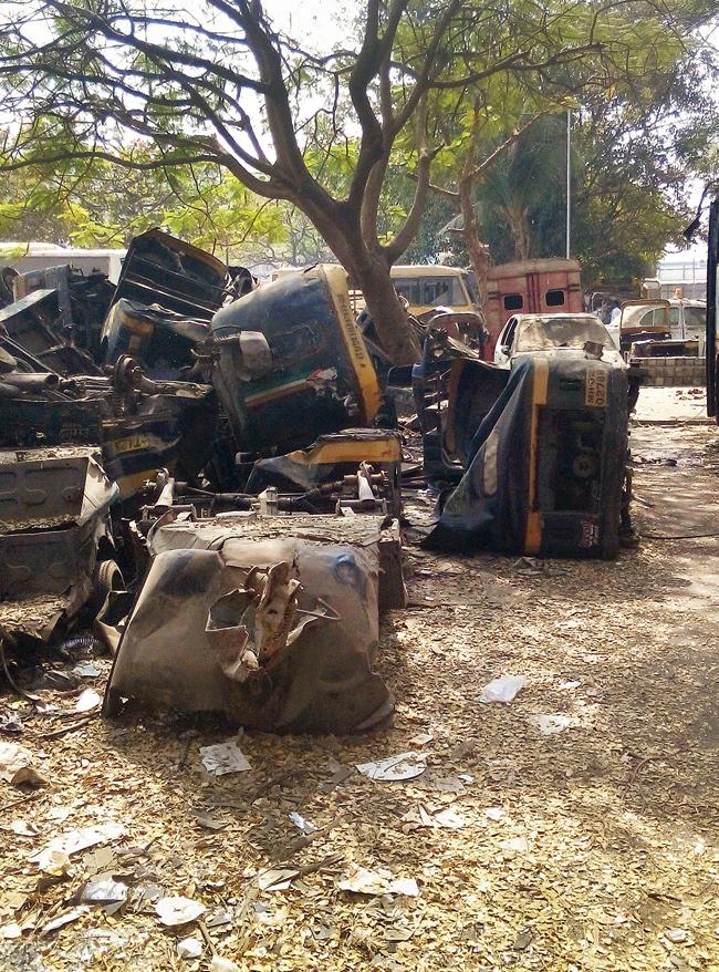 Mangled remains of three wheelers lying in the open