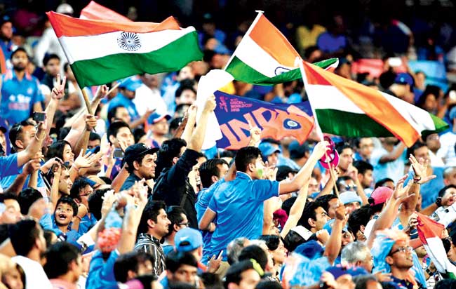 Indian supporters cheer for their team during the clash against South Africa in Melbourne on Sunday. Pic: AP/PTI
