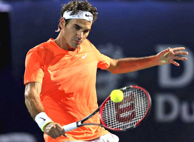 Roger Federer of Switzerland returns the ball to Mikhail Youzhny of Russia during the Dubai Duty Free Tennis Championships in Dubai, United Arab Emirates. Pic/AFP