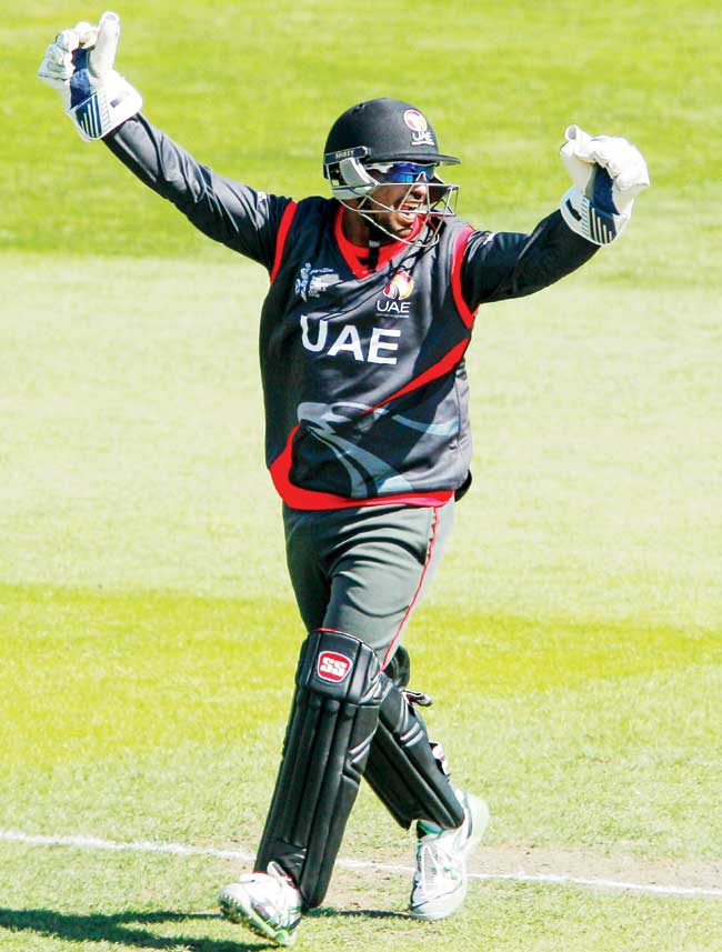 UAE wicketkeeper Swapnil Patil celebrates the wicket of Zimbabwe