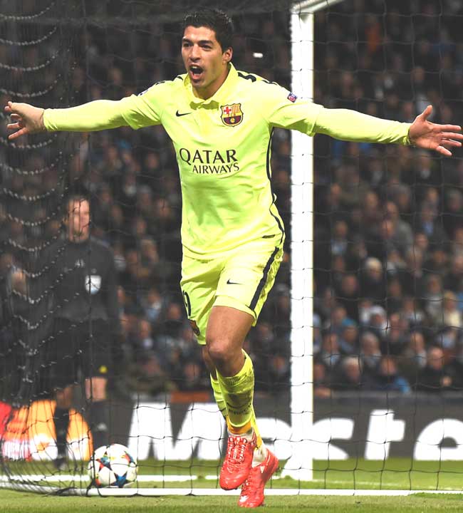 Barcelona-s Uruguayan forward Luis Suarez celebrates scoring his and his team-s second goal as Manchester City-s English goalkeeper Joe Hart R dives during the UEFA Champions League round of 16 first leg football match between Manchester City and Barcelona at the Etihad Stadium in Manchester. Pic/AFP