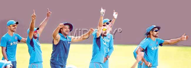 Team India celebrate after knocking down stumps during a training session at the WACA yesterday