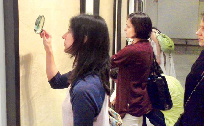Students examine a work by Hema Upadhyay at her solo show at Chemould, Prescott Road