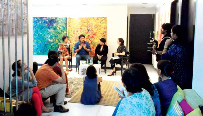 Course students interact with (foreground, seated, left-right) curator-writer Gitanjali Dang, CAMP