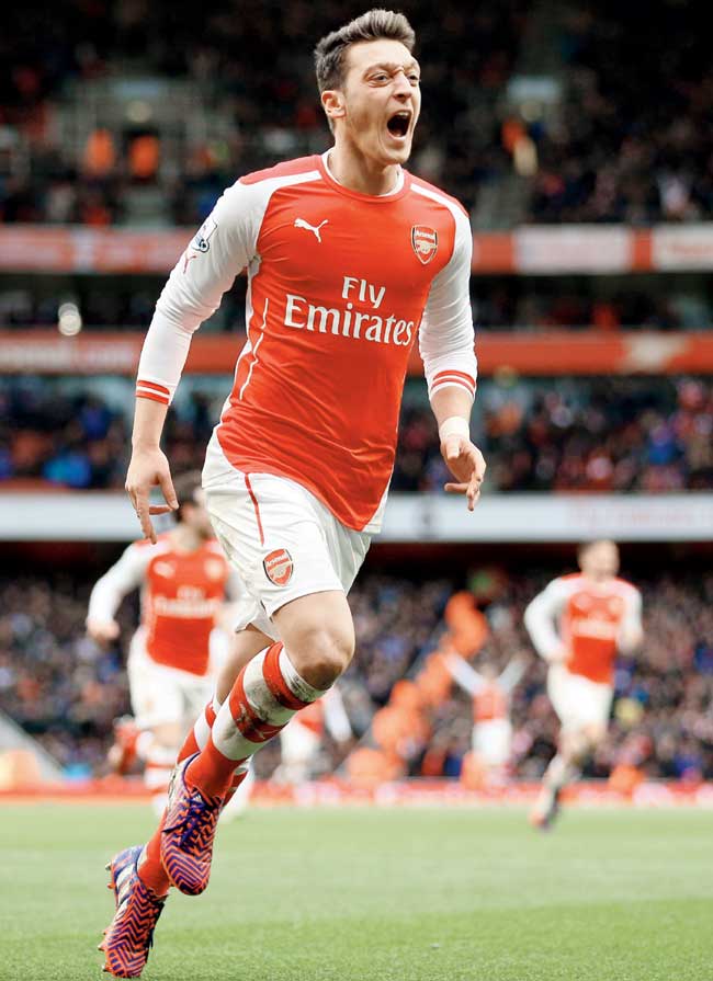 Mesut Ozil celebrates after scoring Arsenal
