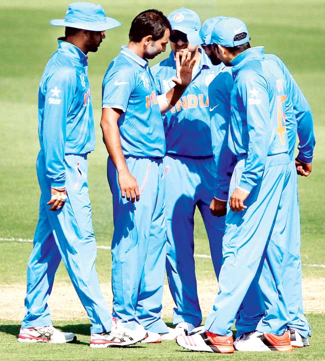 India players look concerned after Mohammed Shami (second from left) suffers an injury to his left hand during the warm-up tie against Australia in Adelaide yesterday. Pics/Getty Images