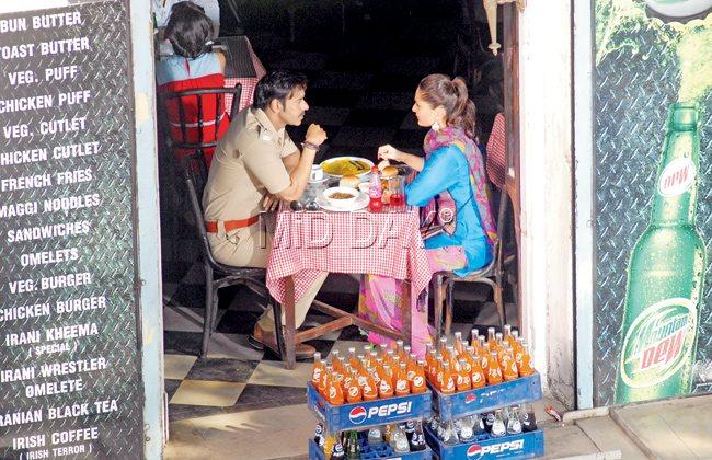 Ajay Devgan and Kareena Kapoor from a scene in Singham, at an Irani café in Matunga