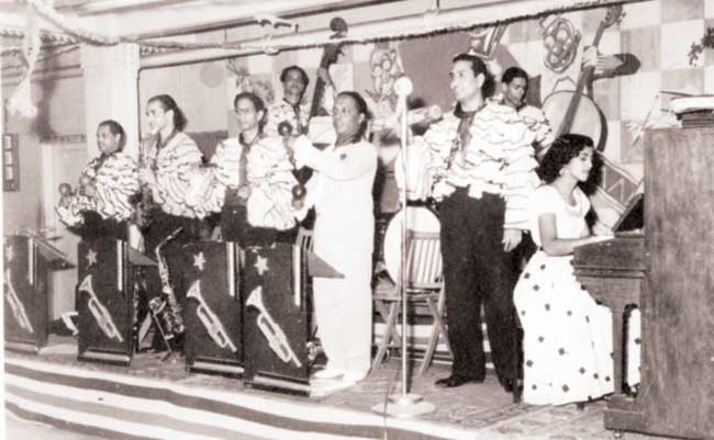 Chic Chocolate and his band in costumes from the film Albela (1951), after one of the songs, in which the band featured, became a hit