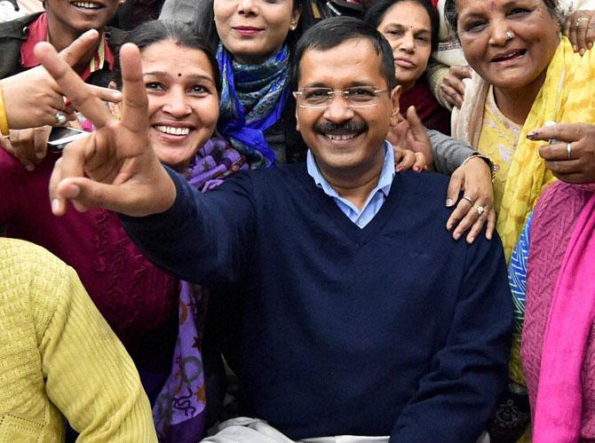 AAP Convener Arvind Kejriwal in a cheerful mood with party volunteers at a meeting in New Delhi on Monday, a day before counting of votes for Delhi polls. Pic/PTI