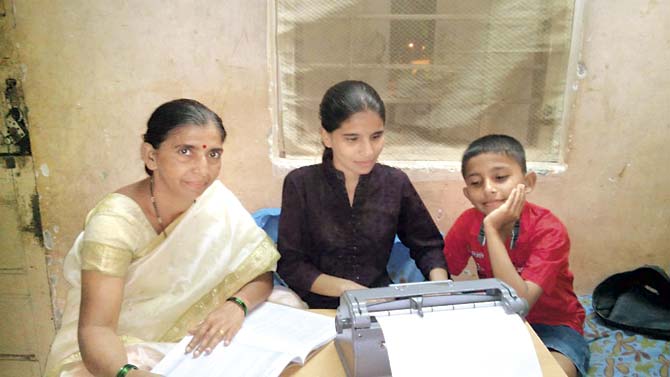 Reshma Gotpagar studies for the HSC exam with her mother and her brother by her side