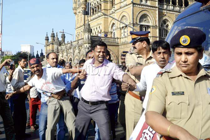 Activists near CST demand the arrest of the accused. Pic/Atul Kamble