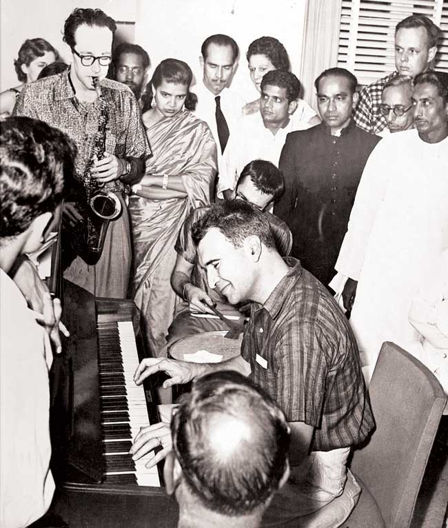 Dave Brubeck (piano, seated), Paul Desmond (saxophone, standing) jamming with musicians in Mumbai (then Bombay)