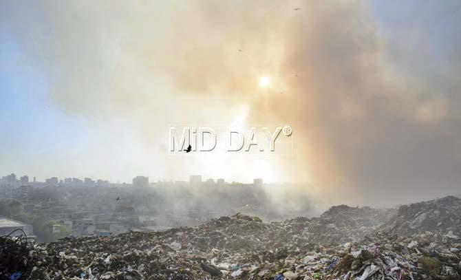While the fire was brought under control yesterday, smoke from the garbage continues to billow in different directions from the dumping ground. Pics/Prashant Waydande