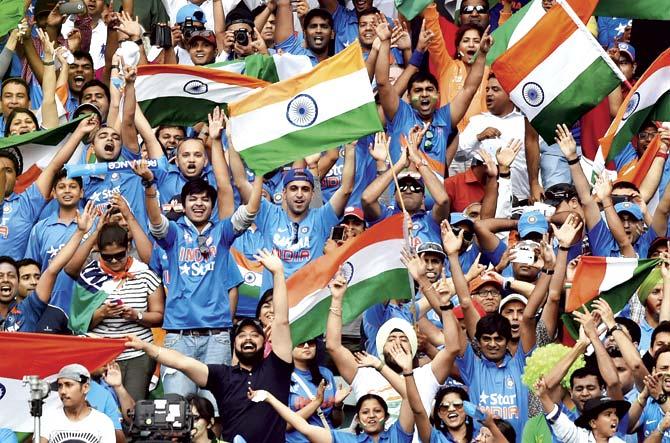 Indian fans celebrate after batsman Virat Kohli scores a century during the India-Pakistan match at the Adelaide Oval on Sunday. Pic/AFP