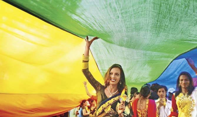 LGBTQ community members carry the rainbow flag through the streets of Mumbai for the Queer Azaadi March. Pic/PTI