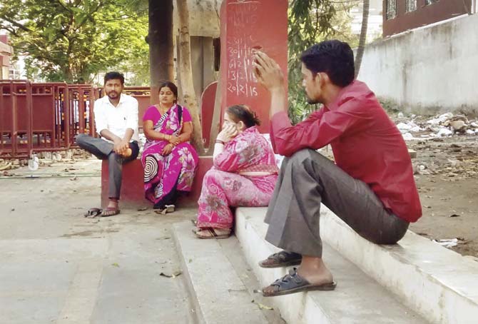 Family members wait outside the MIDC police station, where the minor accused is now being held