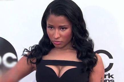 Nicki Minaj carries off a black number without a nip-slip