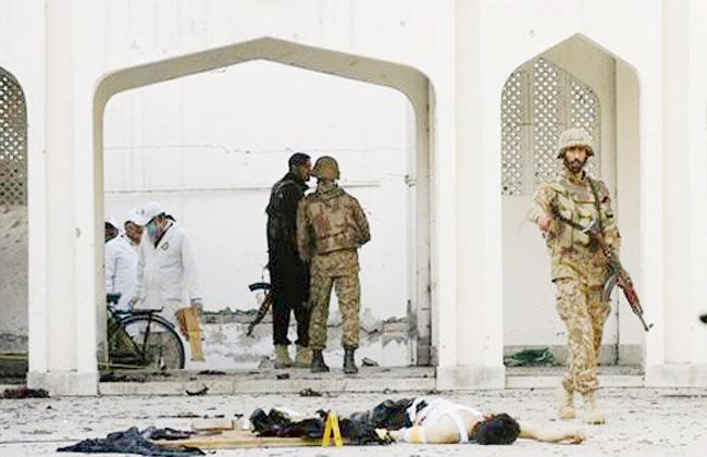 Pakistani security personnel inspect a Shiite Muslim mosque after an attack by Taliban militants in Peshawar on February 13. 