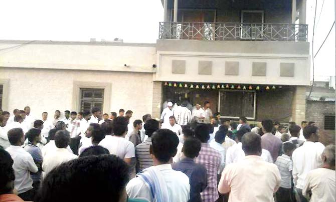A crowd gathered outside Patil’s house in Anjani village