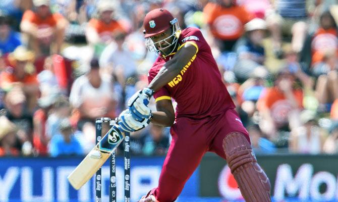 West Indies batsman Andre Russell hits out against the Pakistan bowling during their 2015 Cricket World Cup Group B match in Christchurch.  AFP PHOTO