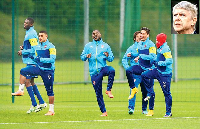 Players warm up during an Arsenal training session. (Inset) Arsene Wenger. Pic/Getty Images