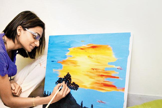 The artist painting at her studio 