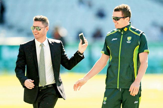 Injured Australian captain Michael Clarke, now doing duty as a television commentator with Peter Siddle of Australia