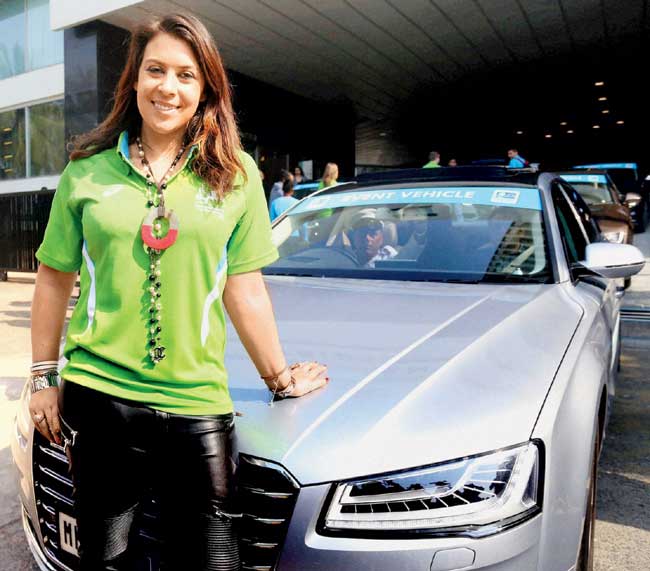Former Wimbledon champ & 2015 Mumbai Marathon brand ambassador Marion Bartoli poses in front of the SCMM-s official lead car in the city yesterday. Pic/PTI