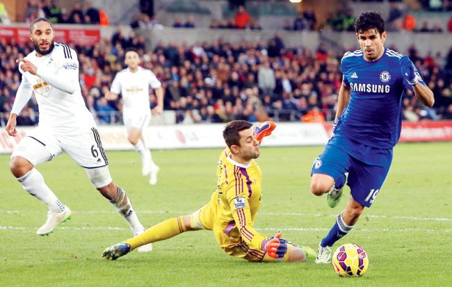 Costa two good: Chelsea striker Diego Costa (right) gets past Swansea City goalkeeper Lukasz Fabianski (in yellow) to score his second goal during their English Premier League match at the Liberty Stadium in Swansea, Wales on Saturday. Pic/AFP