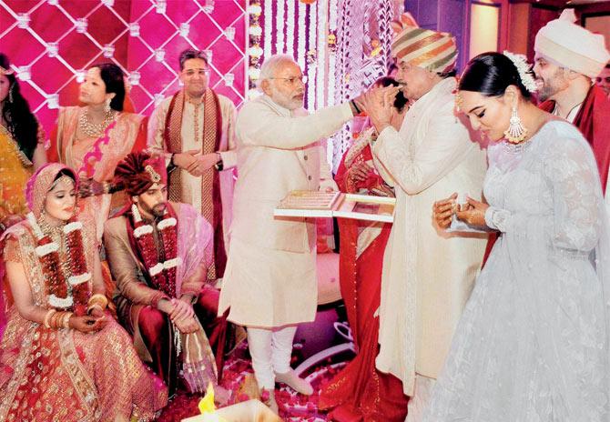 Kussh meetha ho jaye! Prime Minister Narendra Modi feeds a sweet to BJP MP Shatrughan Sinha on the occasion of his son, Kussh Sinha’s wedding to Taruna Agrawal in the city yesterday. Sinha’s daughter, actress Sonakshi, can be seen on the right. She later Tweeted, “Thank you @narendramodi sir for keeping your promise to me! You made our day truly even more special”  Pic/PTI