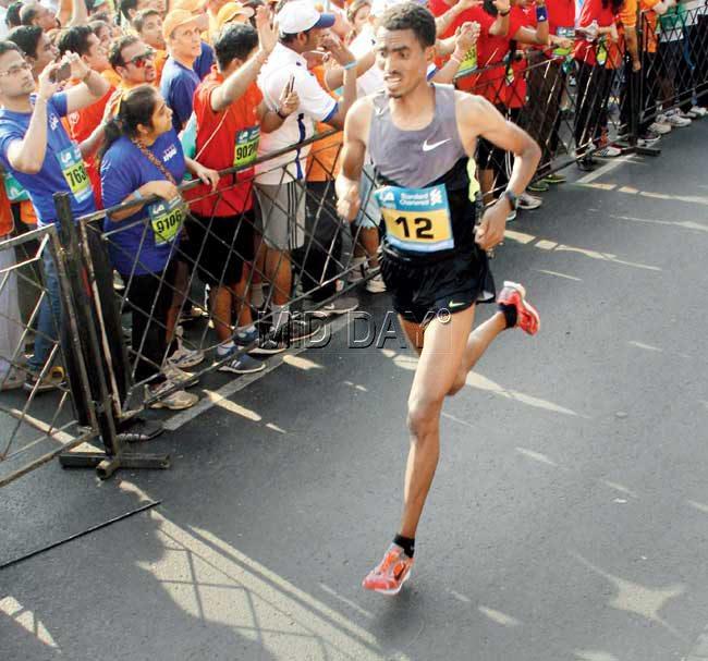 Tesfaye Abera is cheered as he approaches the finish line of the Mumbai Marathon yesterday. Pic/Sameer Markande