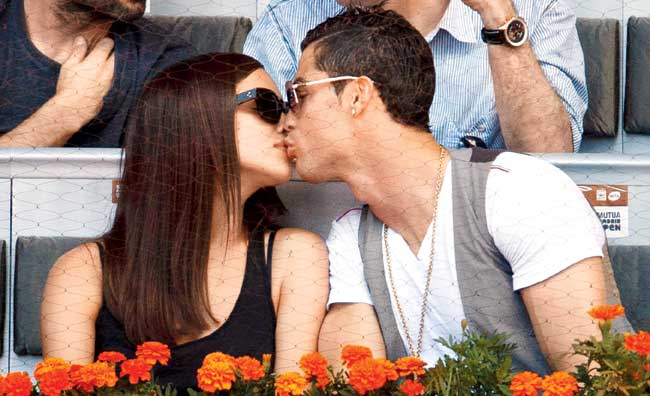 Happier times: Cristiano Ronaldo (right) kisses his girlfriend Irina Shayk during a Madrid Open match in 2013. Pic/Getty Images