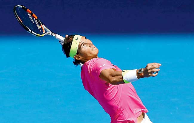 Rafael Nadal serves against Mikhail Youzhny at Melbourne Park yesterday. Pic/Getty Images 