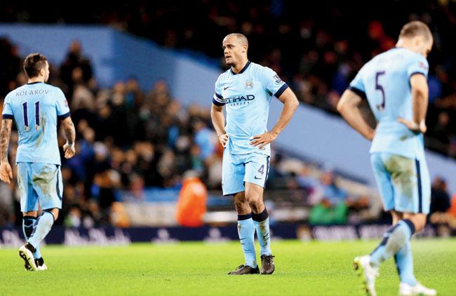 Aleksandar Kolarov (left), Vincent Kompany (centre) and Pablo Zabaleta of Manchester City show their dejection after conceding a goal against Middlesbrough at Etihad Stadium on Saturday. Pic/Getty Images