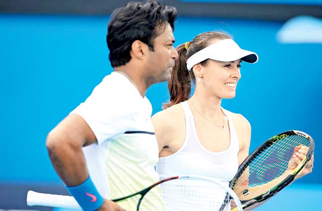Leander Paes discusses tactics with partner  Martina Hingis in Melbourne. Pic/Getty Images