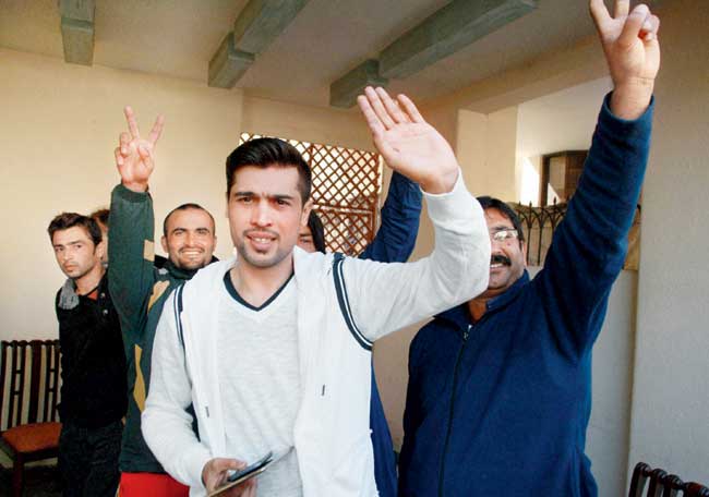 Pakistan fast bowler Mohammad Amir (centre) waves to the media after addressing a press conference in Lahore, yesterday. Pic: AP/PTI