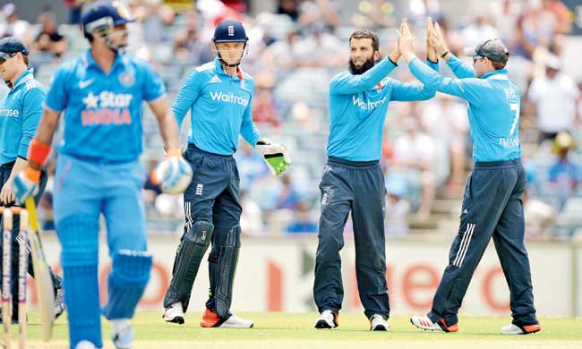 The bearded Moeen Ali celebrates the wicket of Suresh Raina with teammate Ian Bell in Perth yesterday. Pic/Getty Images