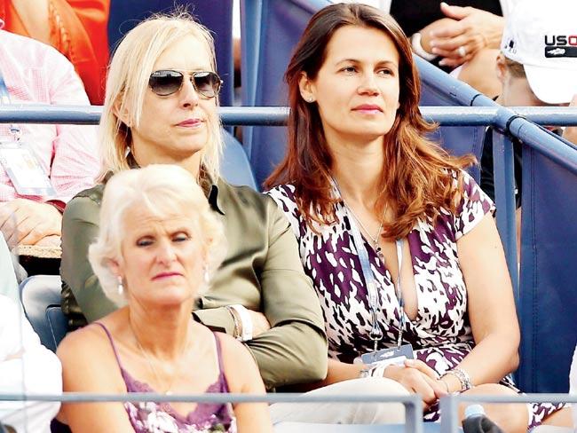 Two close: Tennis legend Martina Navratilova in green and partner Julia Lemigova watch the US Open men-s singles semi-final between Spain’s Rafael Nadal and Richard Gasquet of France at the USTA Billie Jean King National Tennis Center in September 2013. Pic/Getty Images