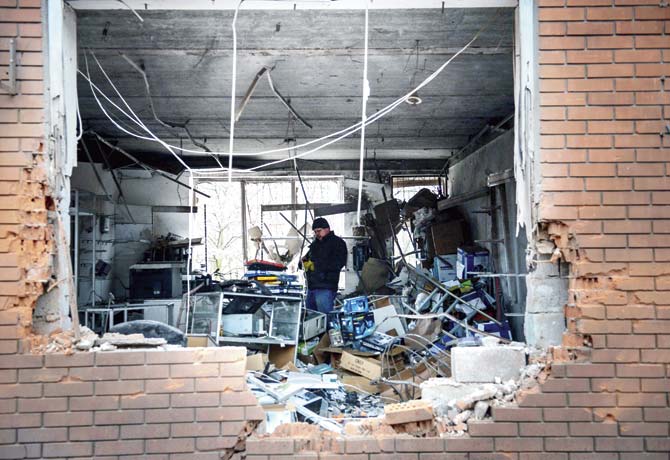 A man stands inside a building damaged by shelling in Mariupol, southern Ukraine, on Saturday. Pic/AFP