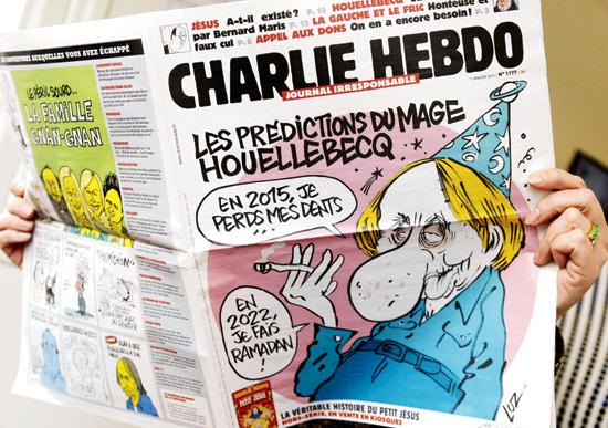 A man reads the latest issue of Charlie Hebdo